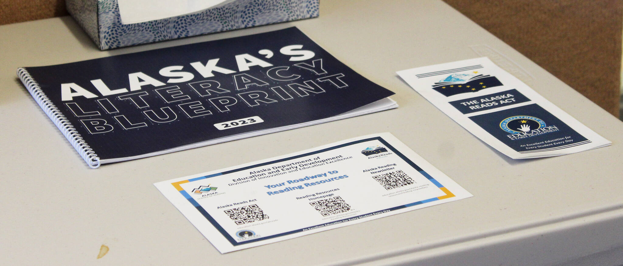 Materials with information about the Alaska Reads Act are displayed on a table near the entrance to Hope School on Wednesday, Oct. 18, 2023, in Hope, Alaska. (Ashlyn O’Hara/Peninsula Clarion)