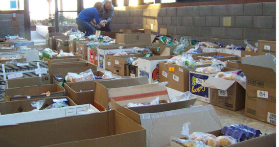 Volunteers help organize more than 200 boxes of food Saturday morning, part of the Lions Club Thanksgiving Basket program. Homer News file photo.