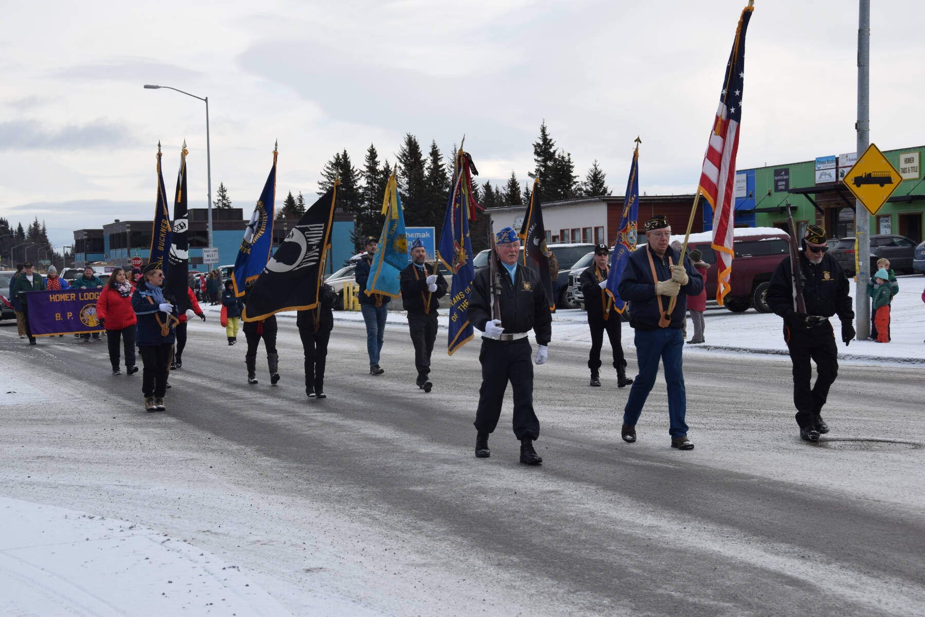 Members of the VFW Post 10221, American Legion Post 16, American Legion Auxiliary, Homer Elks and Emblem Clubs and members of the community march down Pioneer Avenue during the Veterans Day parade on Saturday, Nov. 11, 2023 in Homer, Alaska. (Delcenia Cosman/Homer News)
