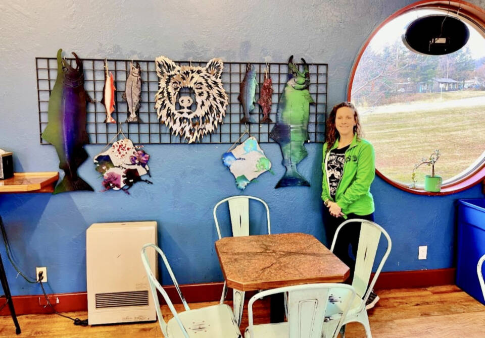 Metal artist Ellie DelliGatti is photographed in the summer of 2023 with a few of her metal designs, available now at Latitude 59 on Lake Street in Homer, Alaska. Photo provided by Ellie DelliGatti