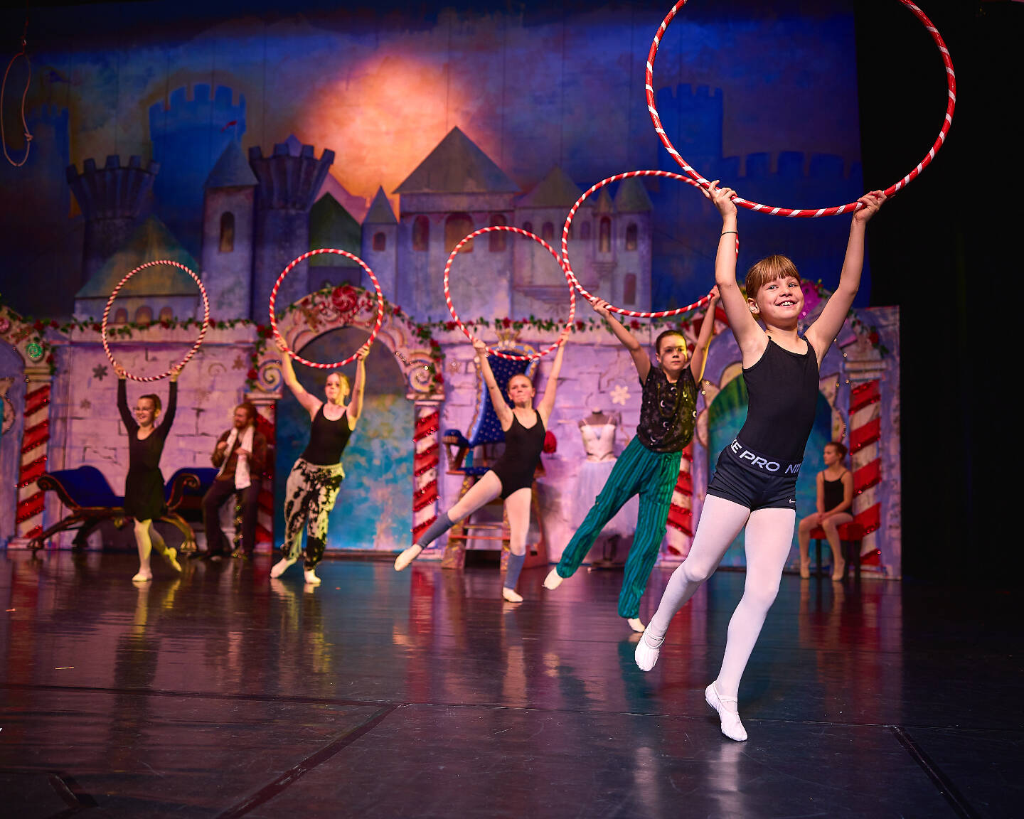 (from left to right) Nutcracker ballet performers Isaiah Kincaid, Brenda Pennington, Signe Jensen, Oona Faucher, and Haddie Kincaid rehearse the “Peppermints” dance onstage at the Homer High School Mariner Theatre on Sunday, Nov. 19, 2023 in Homer, Alaska. August Kilcher (left rear) and Lila Shavelson (right rear) watch the dancers practice. Photo by Chris Kincaid.