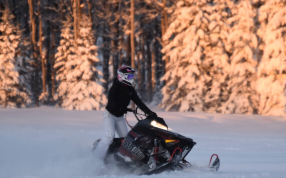 Jake Dye/Peninsula Clarion
A snowmachine rider takes advantage of two feet of fresh snow on a field in Soldotna in December 2022.