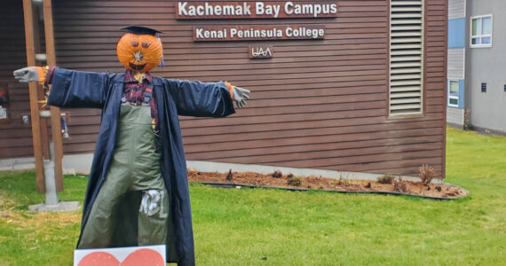A friendly, pumpkin-headed scarecrow stands outside the Pioneer Avenue entrance of Kachemak Bay Campus on Thursday, Nov. 2, 2023 in Homer, Alaska. (Delcenia Cosman/Homer News)