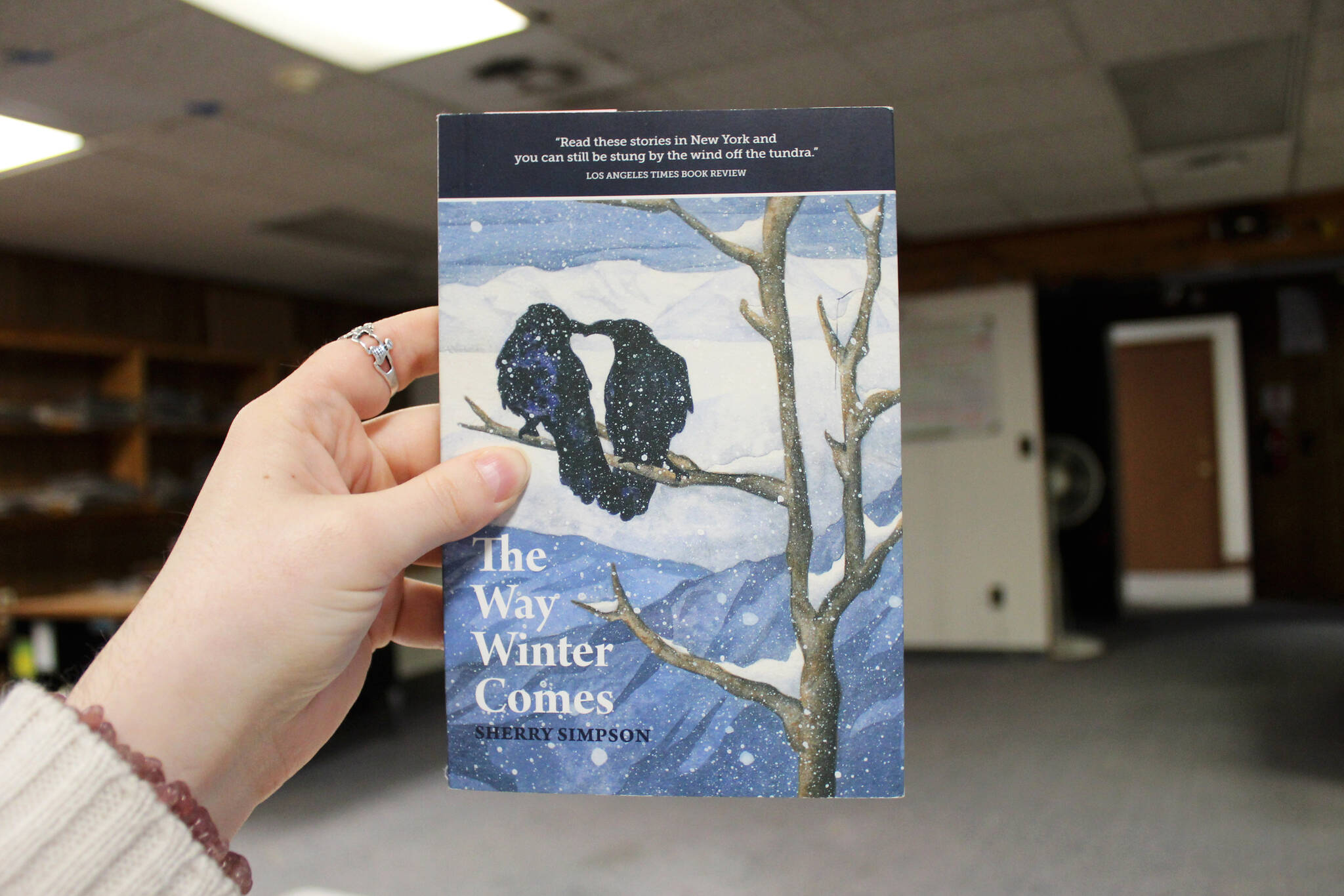 A copy of Sherry Simpson’s “The Way Winter Comes” is held in the Peninsula Clarion offices on Tuesday, Nov. 28, 2023 in Kenai, Alaska. (Ashlyn O’Hara/Peninsula Clarion)