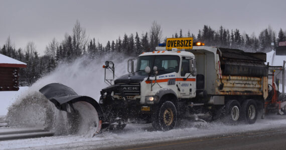 A state plow truck clears snow from the Kenai Spur Highway on Wednesday, Nov. 2, 2022, in Kenai, Alaska. (Jake Dye/Peninsula Clarion)