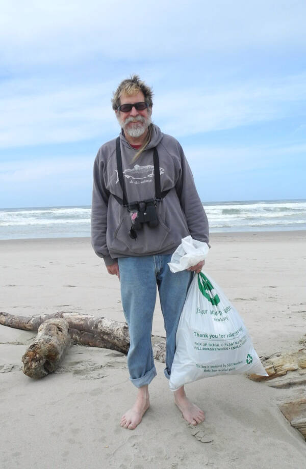 Michael Armstrong collects beach trash in Manzanita, Oregon in April 2014. Photo by Jenny Stroyeck