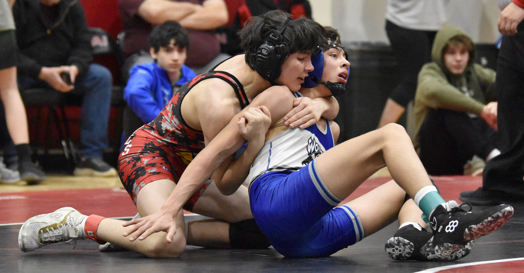 Kenai Central’s Gunnar Stanley and Cordova’s Blake Bailey wrestle at 125 pounds at the Kachemak Conference wrestling tournament at Kenai Central High School in Kenai, Alaska, on Saturday, Dec. 9, 2023. Stanley won an 11-10 decision. (Photo by Jeff Helminiak/Peninsula Clarion)