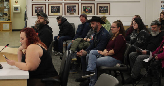 Audience members listen to Iris Fontana, of the Satanic Temple, deliver an invocation during a Kenai Peninsula Borough Assembly meeting on Tuesday, Dec. 12, 2023, in Soldotna, Alaska. Fontana was the last person to deliver an assembly invocation before a new borough policy, which says only borough volunteer chaplains may deliver the invocation, takes effect. (Ashlyn O’Hara/Peninsula Clarion)
