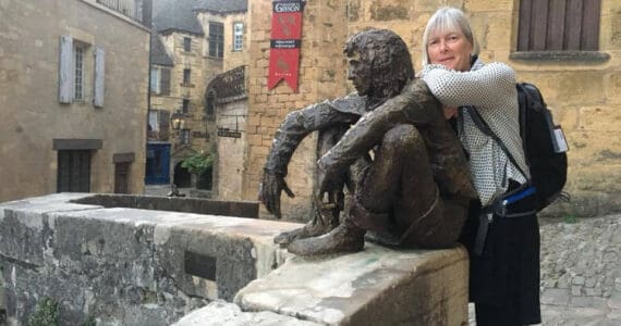 Artist Deb Lowney poses with a statue in France in 2017. Photo provided by Deb Lowney