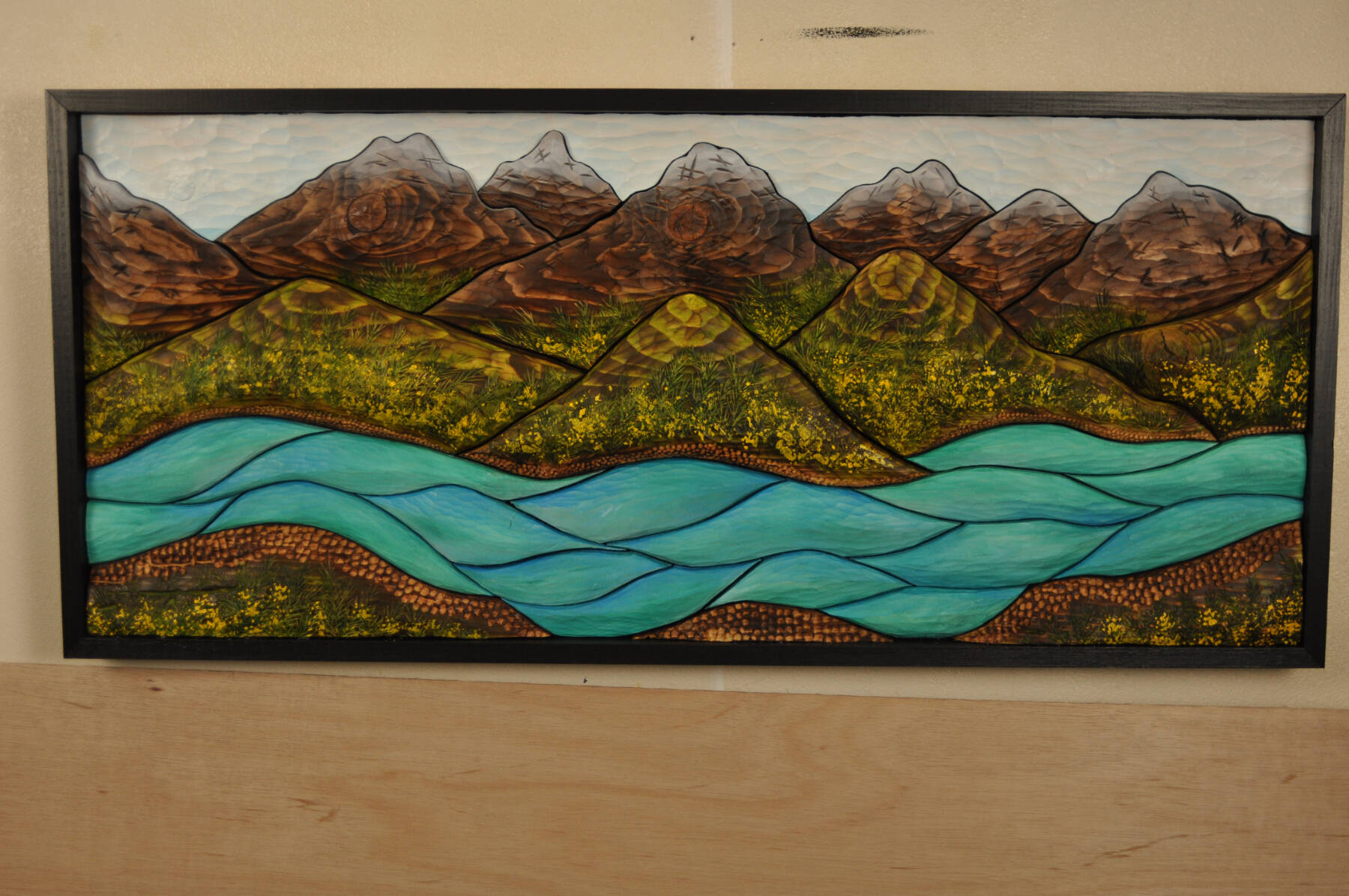 ”Termination Dust on the Kenai River” by Deb Lowney is a torched wood piece made from local spruce, acrylic and oil paint that was part of the 2022-23 Changing Landscapes exhibit at Bunnell Street Arts Center. Photo provided by Deb Lowney