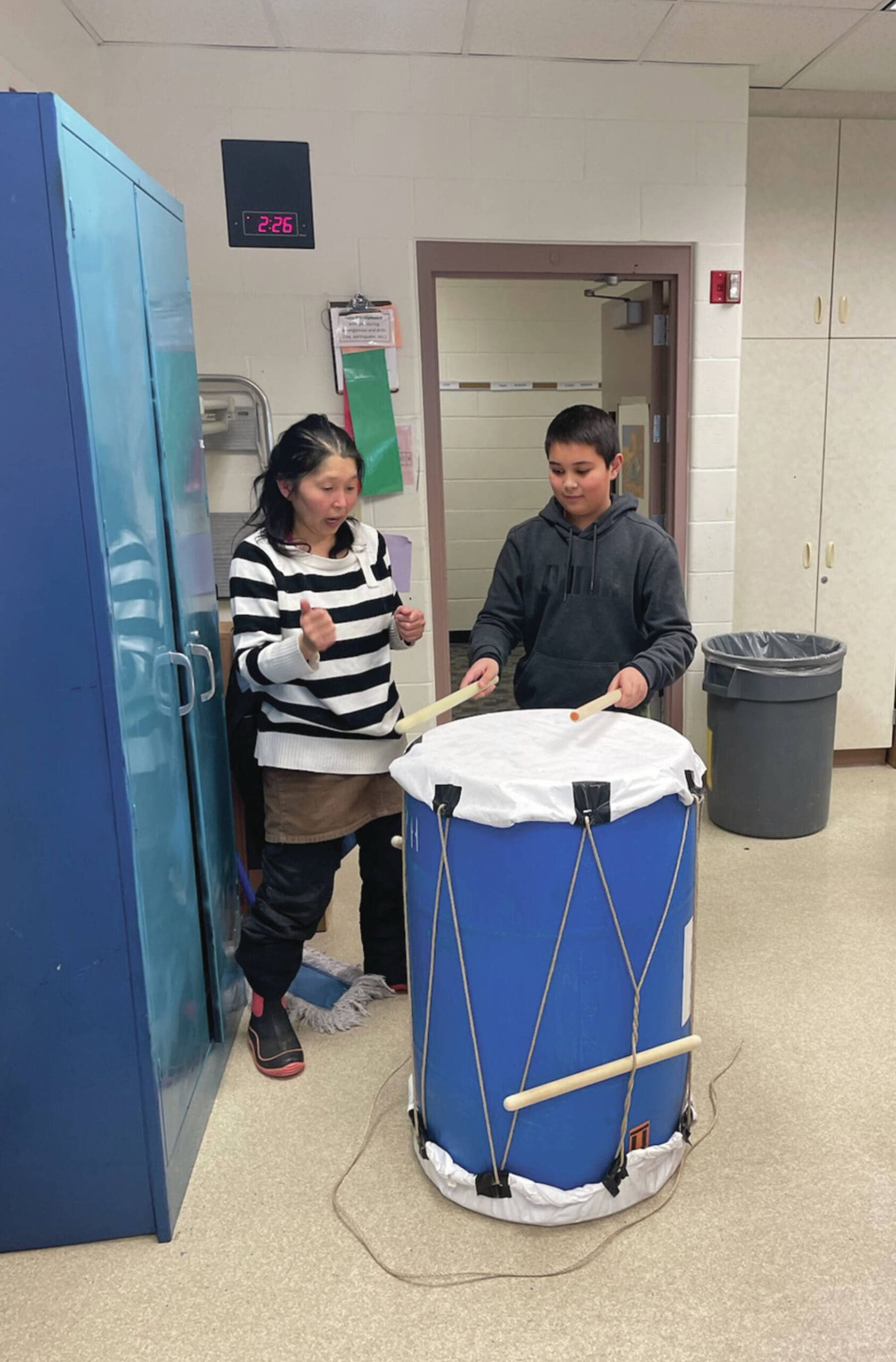 West Homer Elementary School Japanese Club instructor Megumi Beams with Sage Brothers, grade 5 club member practice drumming routine for the upcoming Homer Winter Carnival parade on January 26 at West Homer Elementary School. (Emilie Springer/Homer News)