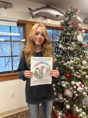 Jade Bernier, winner of the Anchor Point Snow Rondi Button & Banner Contest, holds up her entry for the camera on Jan. 19, 2024 in Anchor Point, Alaska. Photo provded by Amanda Jerde