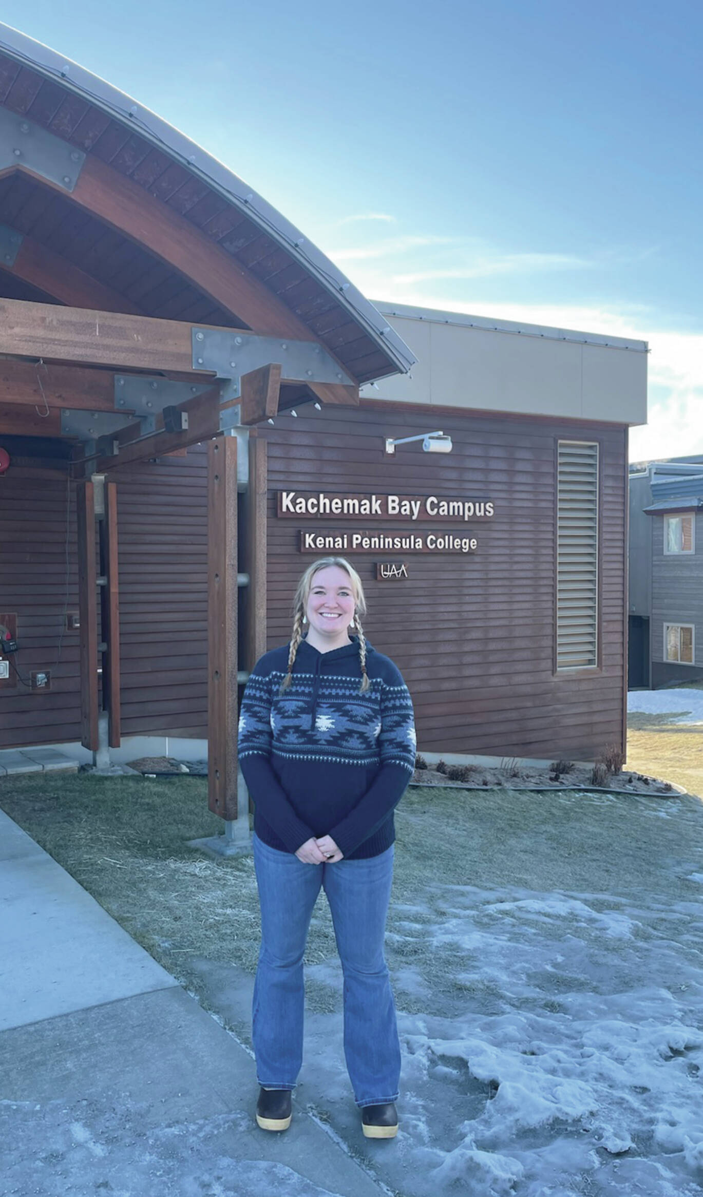 Sara Wilhelm, a 2020 Semester by the Bay alumni and current lab technician stands outside of Pioneer Hall at Kachemak Bay Campus on Jan. 25. (Emilie Springer/Homer News)