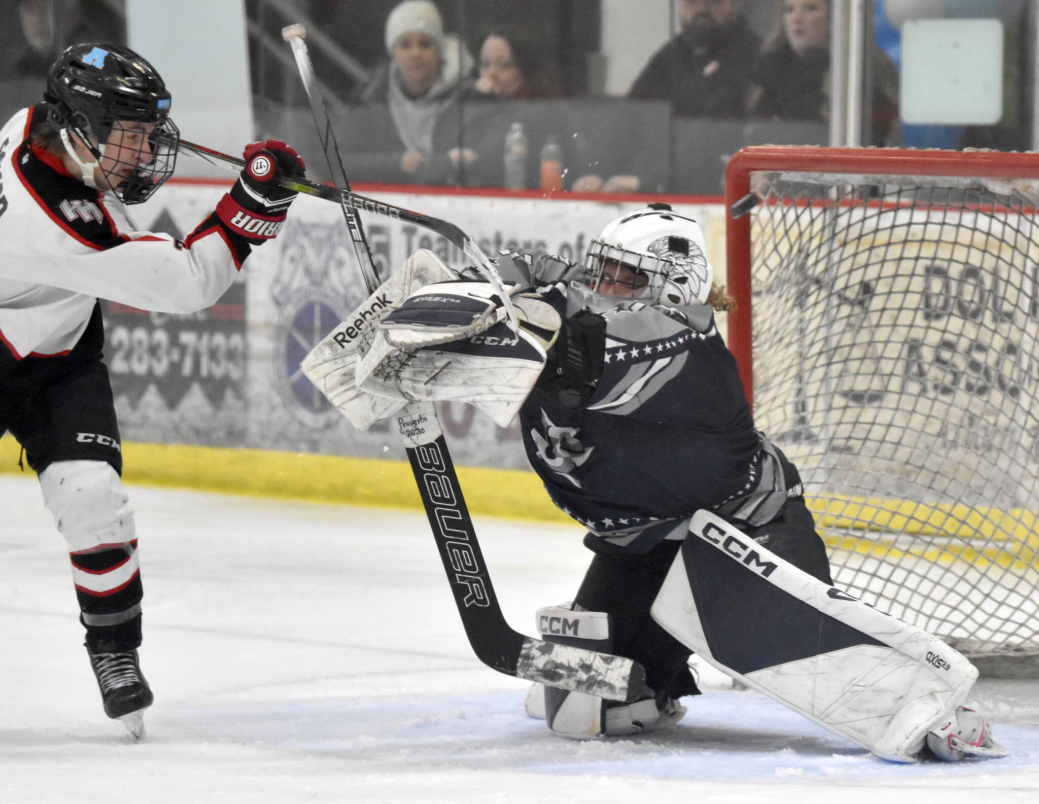 Houston’s Brody Richard gets a puck past Soldotna goalie Tanner Clyde at the Division II state hockey tournament Saturday, Feb. 3, 2024, at the Soldotna Regional Sports Complex in Soldotna, Alaska. (Photo by Jeff Helminiak/Peninsula Clarion)