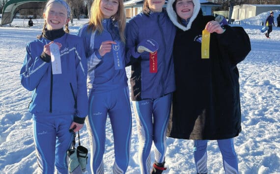 Homer Middle School skiers display their ribbons at the Kenai Invitational Meet on Valentines Day, 2023.  From left to right: Freya Bartlett, Myra Kalafut, Etta Bynagle and Abby Ostrom.