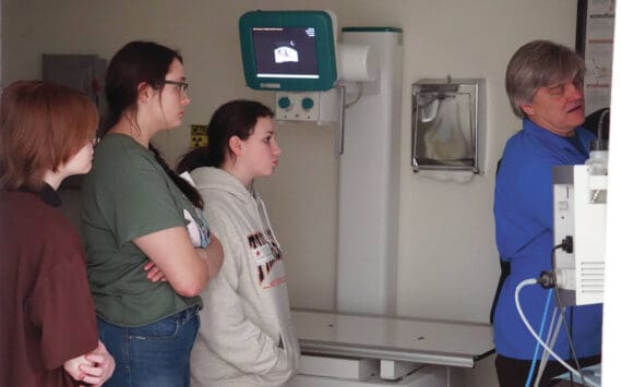 Michelle Duffield/Peninsula Clarion
Jylann Green, Aaliyah Bookey and Isabel Thomas watch Dr. Curt Wisnewski as he shows off some x-rays at Kenai Veterinary Hospital in Kenai on Tuesday.
