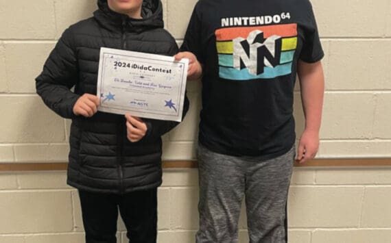 Photo by Emilie Springer
Fireweed Academy 4th grade students Kai Gregoire and Eli Busche-Vold show their ASTE award in the school hallway last week.