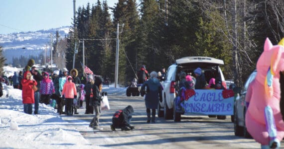 Delcenia Cosman/Homer News
Anchor Point community members watch and wave at the Chapman School Eagle Ensemble float in the annual Snow Rondi parade on Saturday. <ins> on Milo Fritz Road in Anchor Point, Alaska</ins> Turnout at the parade was high despite high winds and below-freezing temperatures.