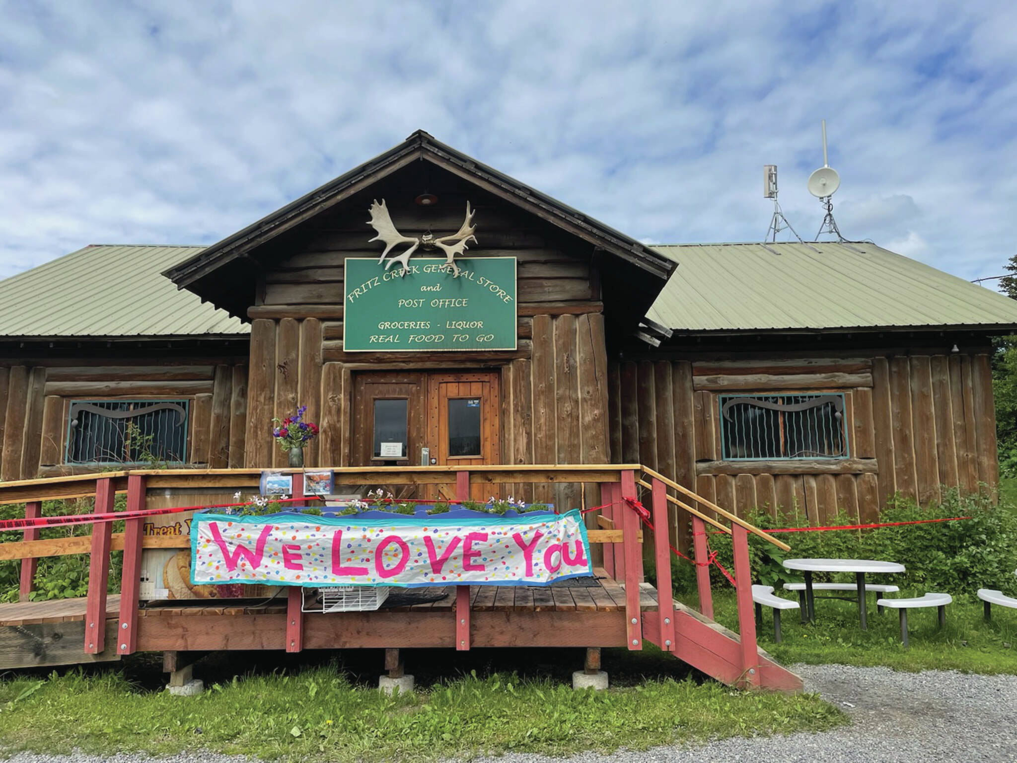 A sign reading “We love you” expresses community support for the Fritz Creek General Store on Saturday, July 8, 2023, after a fire severely damaged it on July 6. (Emilie Springer/Homer News)