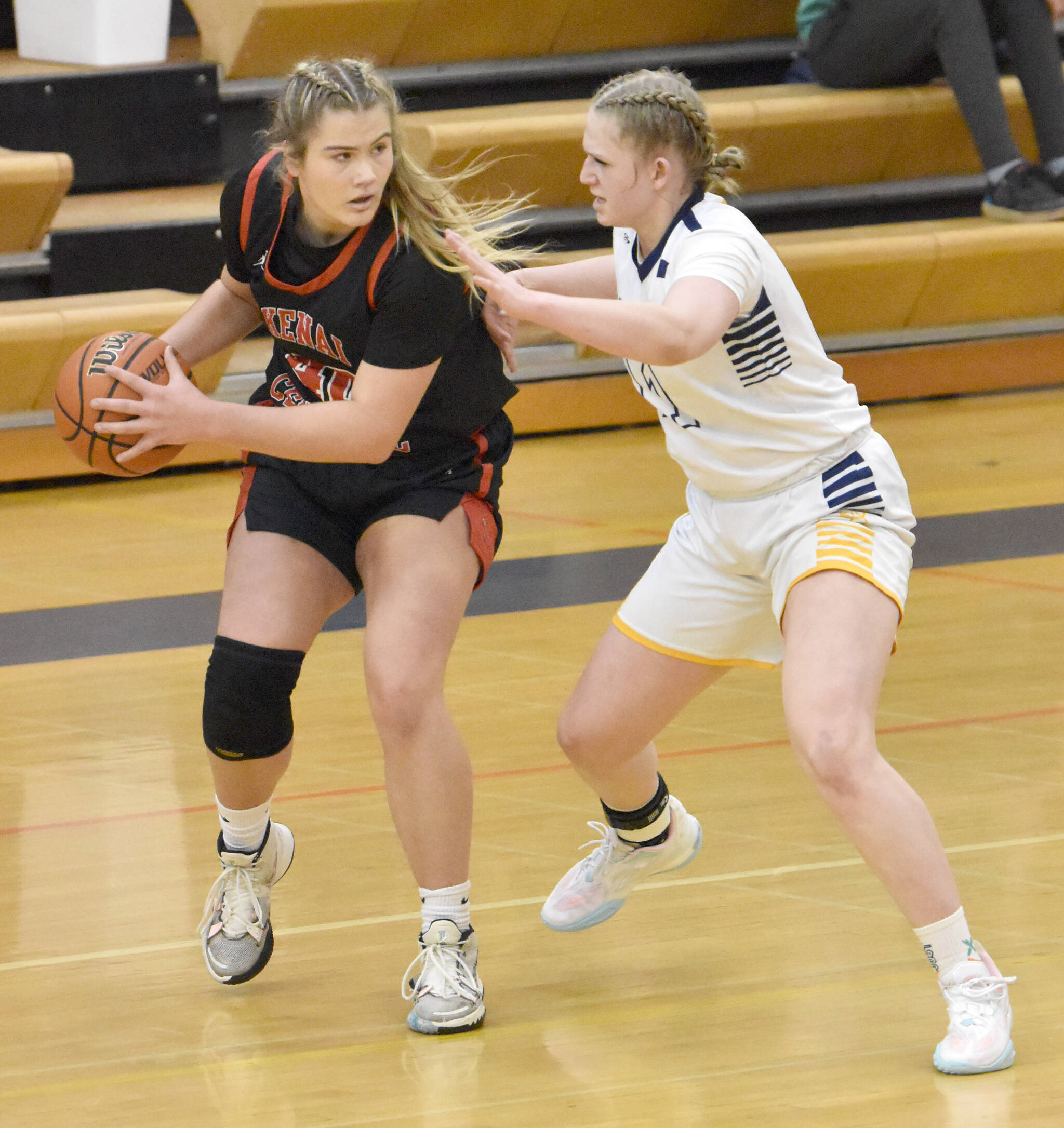 Kenai Central’s Emma Beck holds the ball against Homer’s Sydney Shelby on Saturday, March 9, 2024, at the Peninsula Conference tournament at Homer High School in Homer, Alaska. (Photo by Jeff Helminiak/Peninsula Clarion)