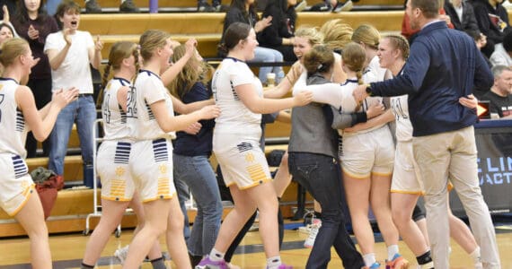 The Homer girls celebrate second place and a Class 3A state berth Saturday, March 9, 2024, at the Peninsula Conference tournament at Homer High School in Homer, Alaska. (Photo by Jeff Helminiak/Peninsula Clarion)