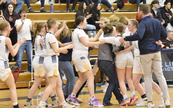 The Homer girls celebrate second place and a Class 3A state berth Saturday, March 9, 2024, at the Peninsula Conference tournament at Homer High School in Homer, Alaska. (Photo by Jeff Helminiak/Peninsula Clarion)