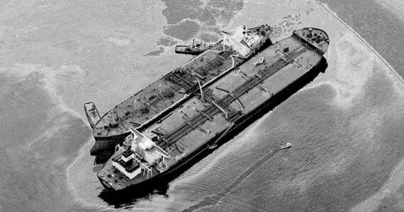 The Exxon Baton Rouge, smaller ship, attempts to off-load crude from the Exxon Valdez that ran aground in Prince William Sound, Valdez, Alaska, spilling over 270,000 barrels of crude oil, shown March 26, 1989. (AP Photo/Rob Stapleton)