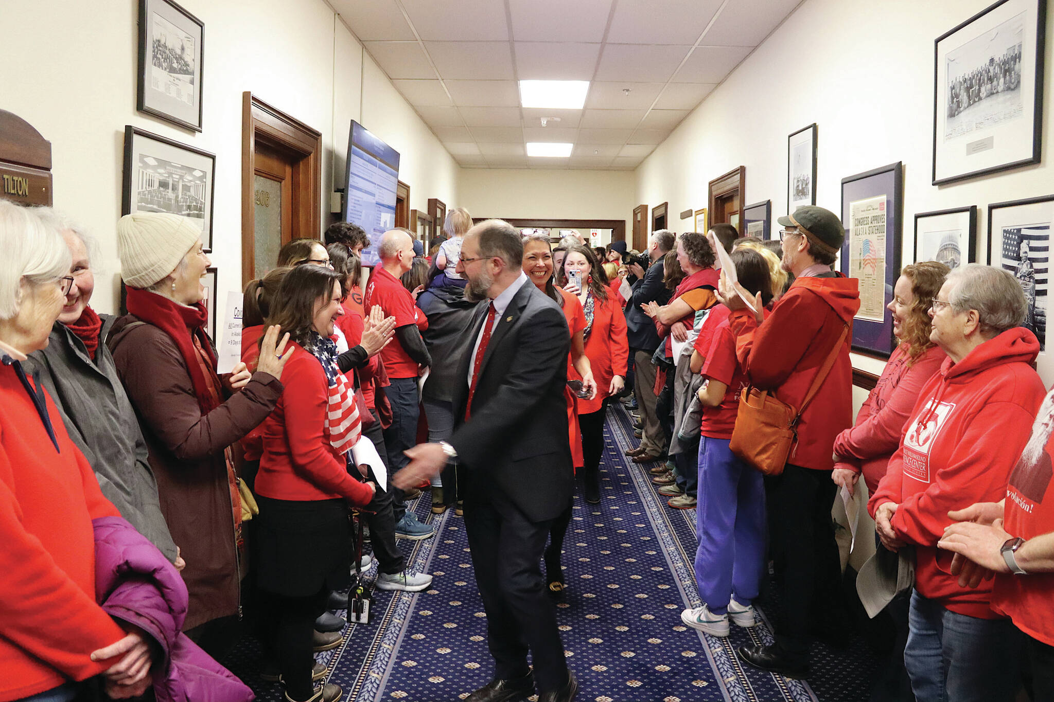State Sen. Jesse Kiehl, a Juneau Democrat, greets educators and other people rallying in a hallway of the Alaska State Capitol just before the Legislature’s override vote on Senate Bill 140 on Monday, March 18, 2024. (Mark Sabbatini / Juneau Empire)