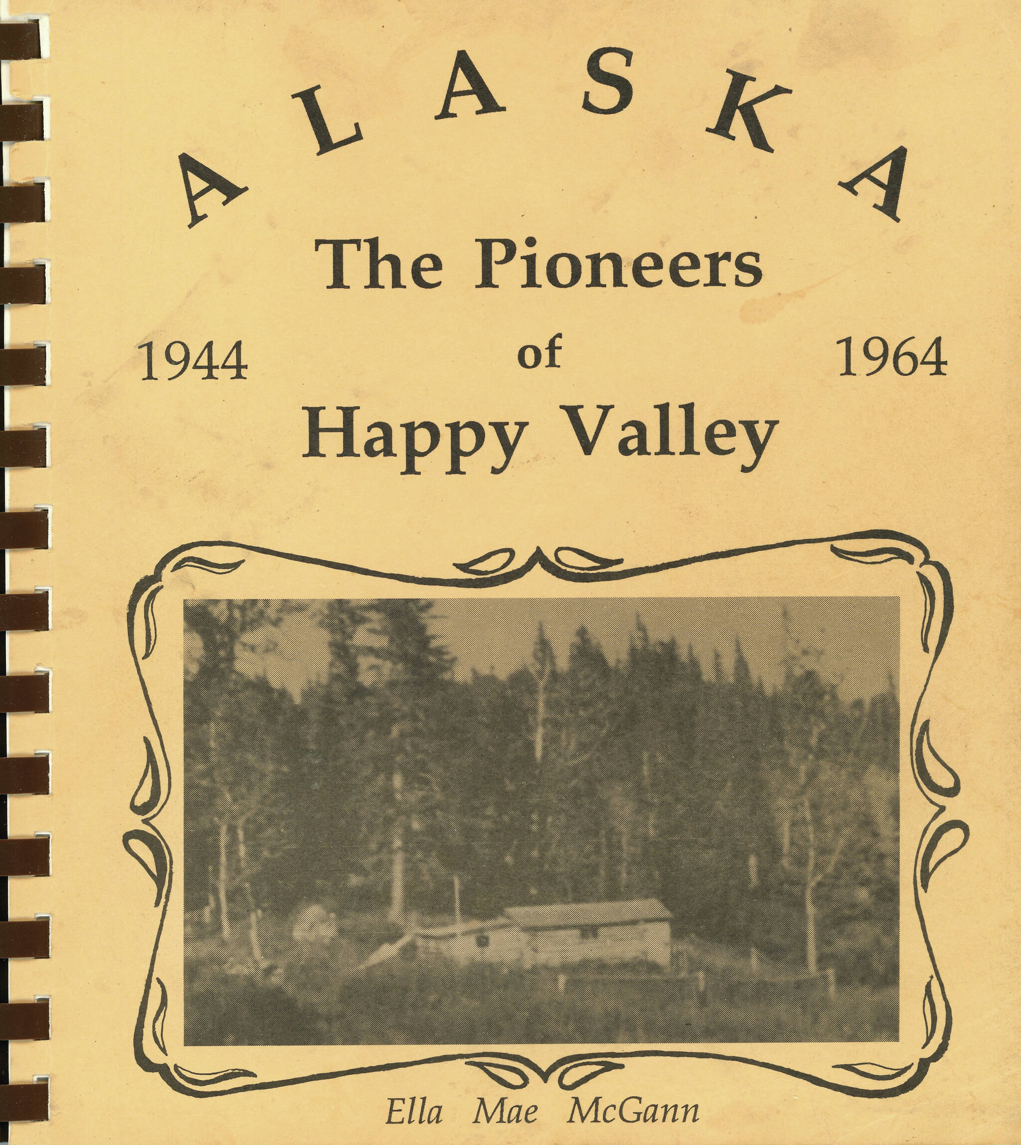 Cover image courtesy of Adrienne Walli Sweeney
The cover of Ella Mae McGann’s history book, “The Pioneers of Happy Valley, 1944-1964,” shows the original homesteading cabin of Homer and Nell Crosby.