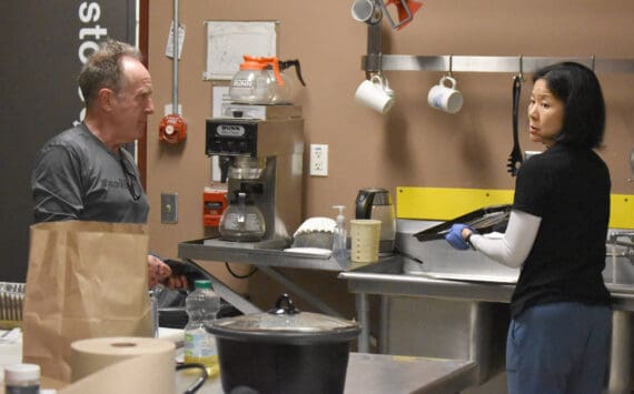 John Bryan and Candace Nakagawa, Co-Directors of Sports Science, Strength and Conditioning, clean up the kitchen after preparing a meal for the Kenai River Brown Bears at the Soldotna Regional Sports Complex in Soldotna, Alaska, on Friday, March 29, 2024. (Photo by Jeff Helminiak/Peninsula Clarion)