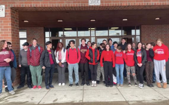 Homer High School students who joined schools from around the state in a high school walkout pose near the end of the event, on Thursday, April 4, 2024, in Homer, Alaska. Not all students who attended the event are in the image. (Photo by Emilie Springer/Homer News)