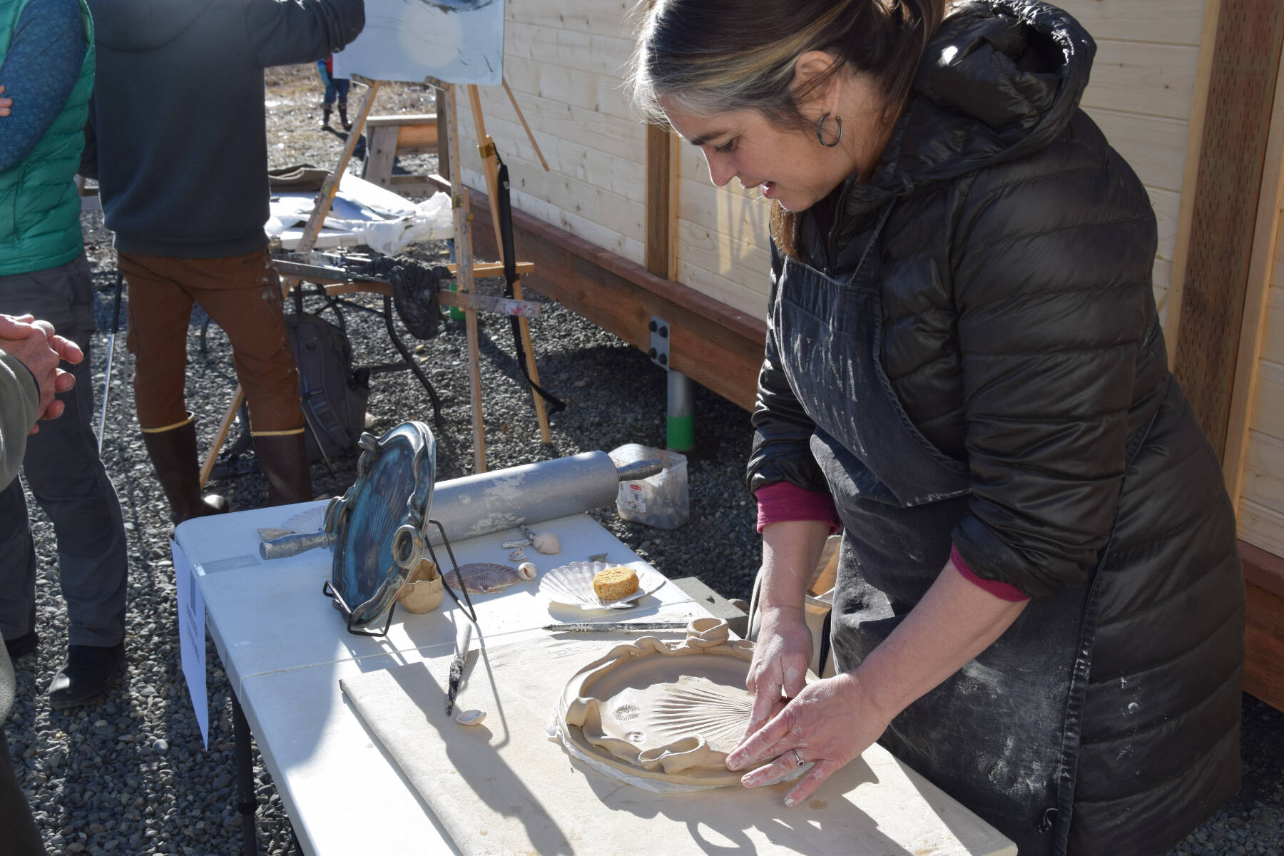 Maygen Lotscher crafts a functional platter from clay at the Ready, Set, Art! fundraiser, benefiting the Ptarmigan Arts Visual Arts Scholarship Fund, on Saturday, April 13, 2024 at Grace Ridge Brewery in Homer, Alaska. (Delcenia Cosman/Homer News)