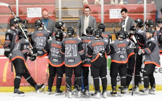 Head coach Taylor Shaw (center) talks to the Kenai River Brown Bears during a timeout at the Soldotna Regional Sports Complex in Soldotna, Alaska, on Saturday, March 23, 2024. (Photo by Jeff Helminiak/Peninsula Clarion)