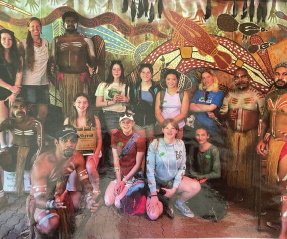 Photo provided by the Homer High School Library
Homer High School students and teacher Erin Brege pose with an indigenous dance group in Kuranda, Australia in March 2024. The photo is on display with several others and a series of Australia guide books in the Homer High School Library.