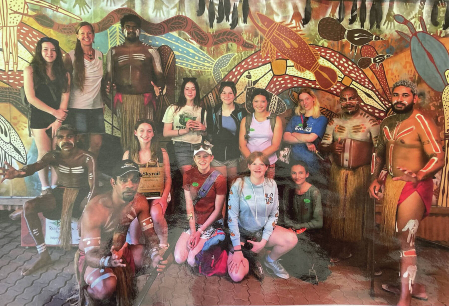 Photo provided by the Homer High School Library
Homer High School students and teacher Erin Brege pose with an indigenous dance group in Kuranda, Australia in March 2024. The photo is on display with several others and a series of Australia guide books in the Homer High School Library.