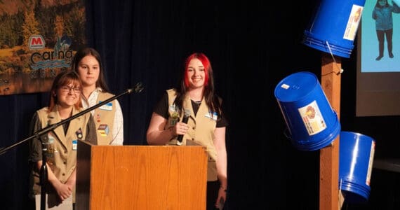 Girl Scout Troop 210, which includes Caitlyn Eskelin, Emma Hindman, Kadie Newkirk and Lyberty Stockman, present their “Bucket Trees” to a panel of judges in the 34th Annual Caring for the Kenai Competition at Kenai Central High School in Kenai, Alaska, on Thursday, April 18, 2024. (Jake Dye/Peninsula Clarion)