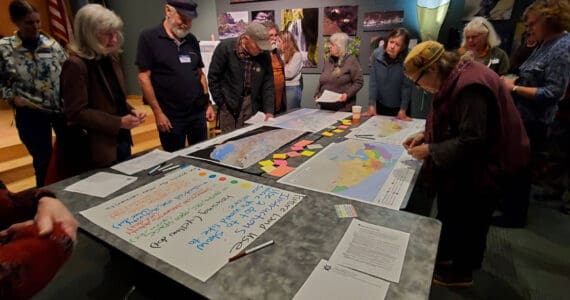 Attendees of the Comprehensive Plan Open House give feedback on future land use in Homer on Thursday, March 28, 2024 at the Alaska Maritime National Wildlife Refuge Visitor Center auditorium in Homer, Alaska. (Delcenia Cosman/Homer News)