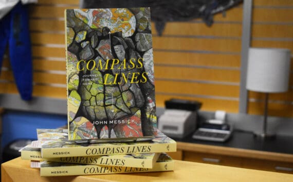 John Messick’s “Compass Lines” is displayed at the Kenai Peninsula College Bookstore in Soldotna, Alaska on Tuesday, March 28, 2023. The copy at the top of this stack is the same that reporter Jake Dye purchased and read for this review. (Jake Dye/Peninsula Clarion)