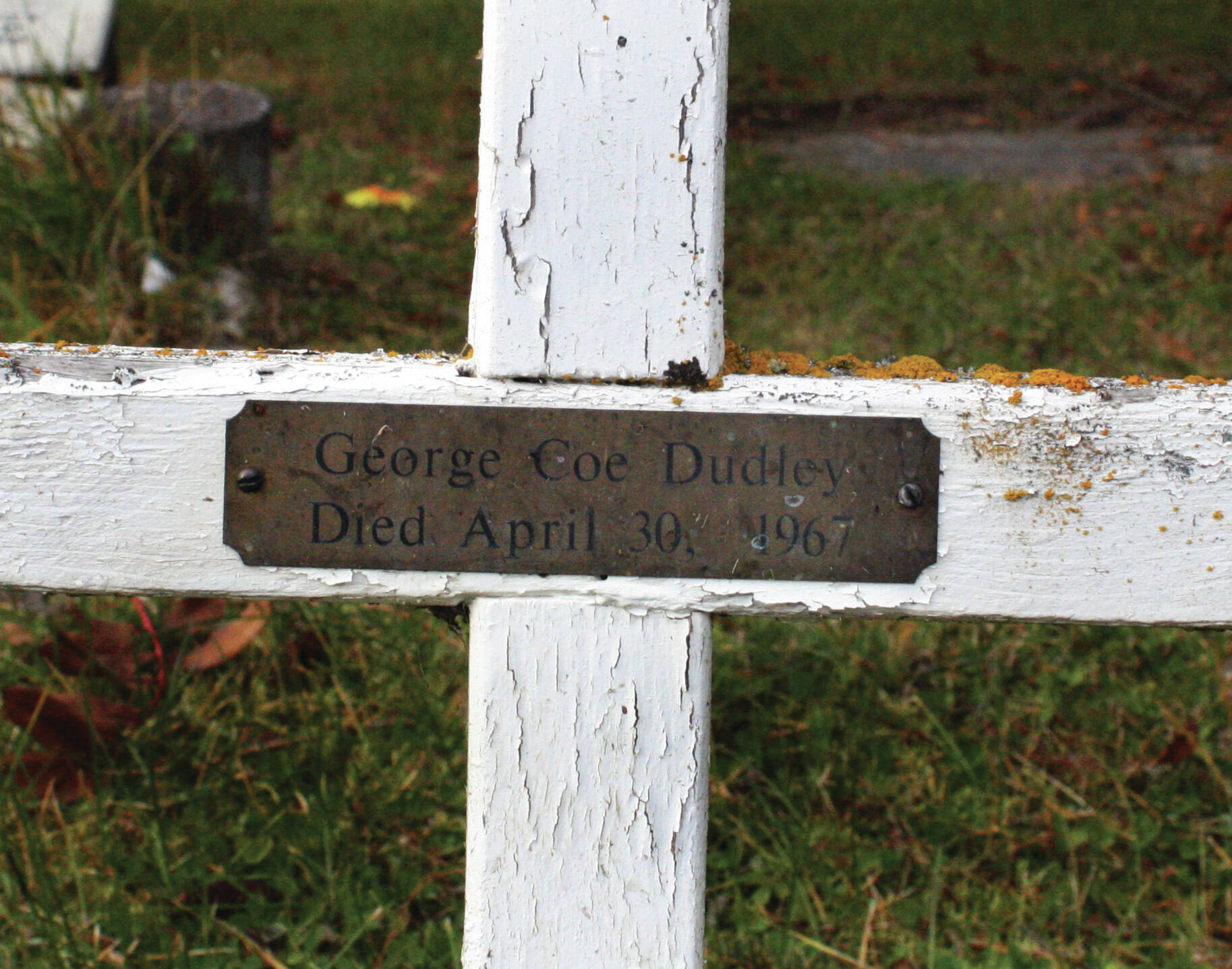 Clark Fair photo
This white, wooden cross and small brass plate in the Kenai City Cemetery mark the last resting place of George Coe Dudley. Getting him into the grave turned out to be no simple task.