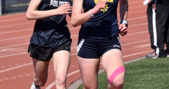 Homer’s Daisy MossWalker leads Soldotna’s Tania Boonstra in the 1,600 meters. Boonstra would pass MossWalker for the victory Saturday, April 27, 2024, at the Kenai Invitational at Kenai Central High School in Kenai, Alaska. (Photo by Jeff Helminiak/Peninsula Clarion)