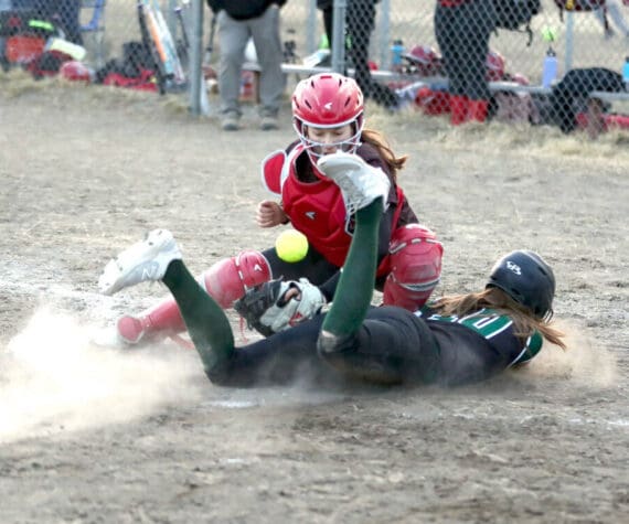 (Bruce Eggleston/matsusports.net) Colony’s Kara Macy slides into home safely as the ball bounces in front of Kenai Central catcher Maggie Grenier at the Rally in the Valley tournament Thursday, April 25, 2024, at Colony Middle School in Palmer.