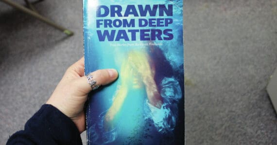Ashlyn O’Hara/Peninsula Clarion
A copy of “Drawn from Deep Waters: True Stories from the Kenai Peninsula,” is held on Thursday in Kenai.