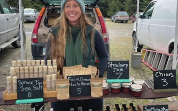 Opening day at the Homer Farmer’s Market on May 25, Megan Long with Wild Wellness Farm stands in front of her products. Emilie Springer/ Homer News.