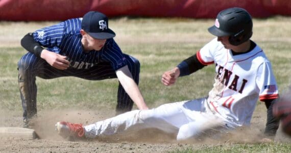 Soldotna second baseman Brett Hostetler tags out Kenai Central's Braden Smith on Saturday, May 10, 2025, at the Kenai Little League fields in Kenai, Alaska. (Photo by Jeff Helminiak/Peninsula Clarion)