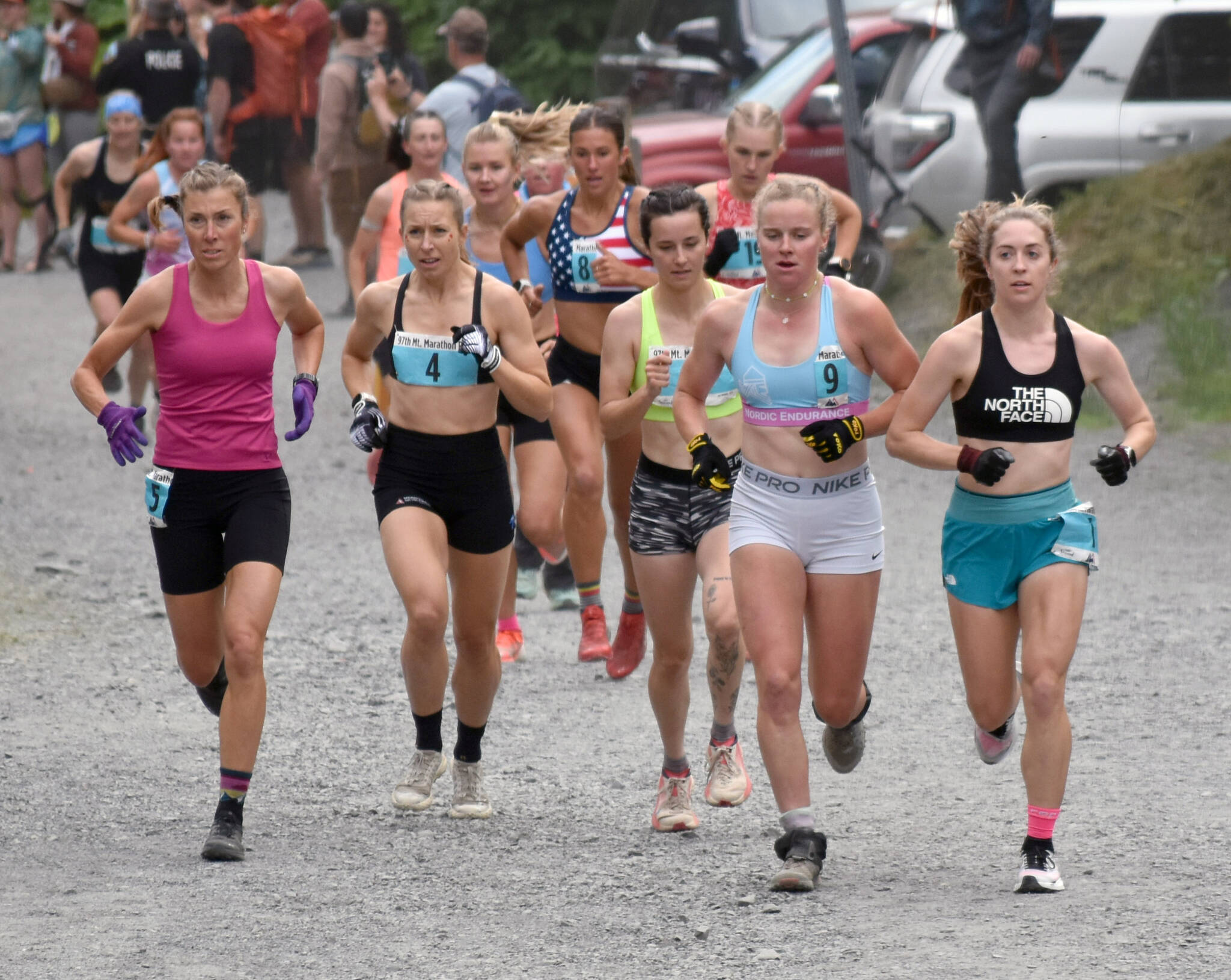 Palmer’s Christy Marvin, 44; British Columbia’s Kalie McCrystal, 37; Fairbanks’ Kendall Kramer, 23; Fairbanks’ Rosie Fordham, 23; and Anchorage’s Klaire Rhodes, 27, approach the mountain during the women’s race at the Mount Marathon Race on July 4, 2025, in Seward, Alaska. (Photo by Jeff Helminiak/Peninsula Clarion)