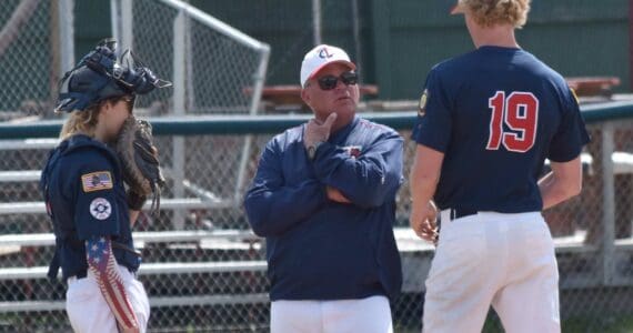 American Legion Post 20 Twins head coach Robb Quelland talks with catcher Ari Miller and pitcher Jacob Joanis during a game against West on Friday, June 13, 2025, at Coral Seymour Memorial Park in Kenai, Alaska. (Photo by Jeff Helminiak/Peninsula Clarion)