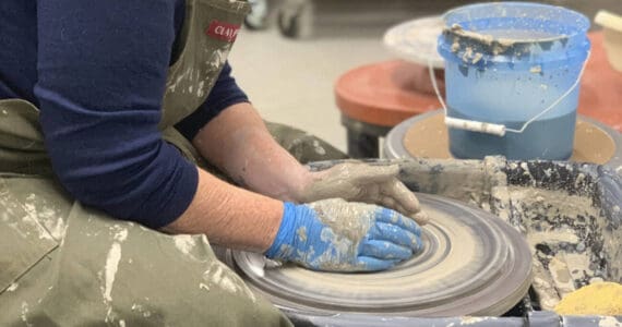 A community member works with clay on a wheel in the ceramics studio at Homer Council on the Arts in Homer, Alaska. Photo provided by Homer Council on the Arts