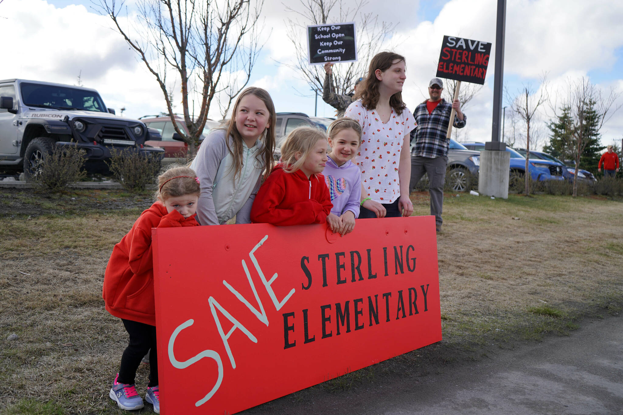 Students stand during a protest against the possible closure of Sterling Elementary School along the Sterling Highway in Soldotna, Alaska, on Saturday, May 3, 2025. (Jake Dye/Peninsula Clarion)