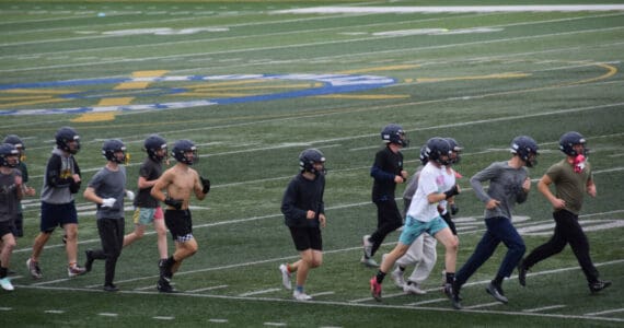 The Homer Mariner football team warms up during practice on Friday, August 8, 2025 on the terf at Homer High School. (Chloe Pleznac/Homer News)