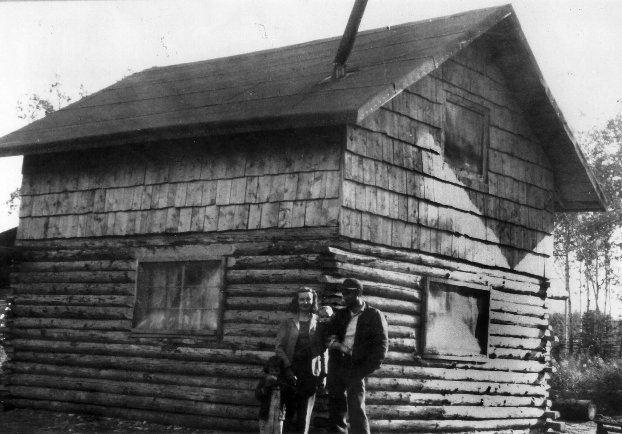Howard and Maxine Lee, with their two children, pose behind their newly completed home in Soldotna in 1950. This structure, which became Soldotnas first post office, stood on part of the homestead that contained a large gravel pit that is now home to the Kenai Peninsula Boroughs administration building. (Photo Soldotna Historical Society)
